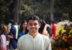Smiling young man in traditional attire at an Indian festival in Bhubaneswar.